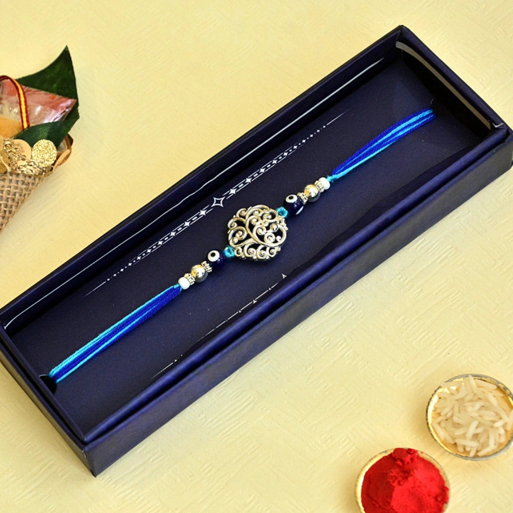 Elegant Evil Eye Pure Silver Rakhi – RK-122 | Silver Filigree Charm with Blue Thread for Style & Protection