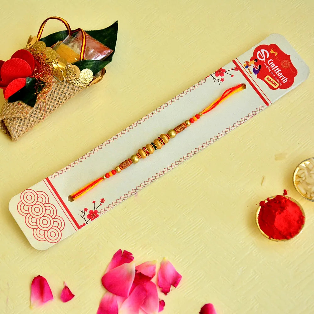 Festive Elegance Rakhi – RK-128 | Bright Orange Thread with Ornate Beads