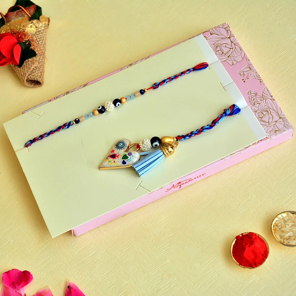 Designer Bhaiya Bhabhi Rakhi Set – RK-135 | Blue-Red Thread with Heart Charm & Beaded Bracelet