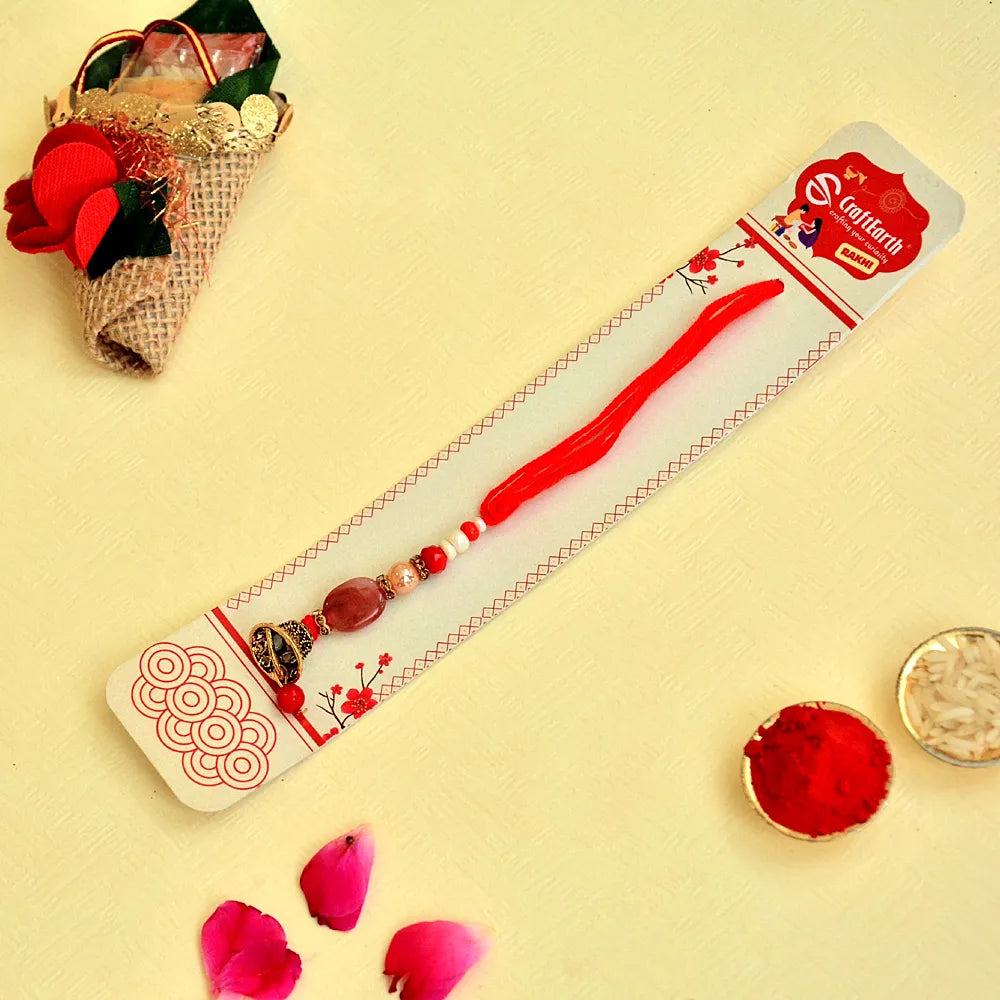 Red Bell Lumba Rakhi – RK-136 | Traditional Design with Beads & Golden Ghungroo for Bhabhi