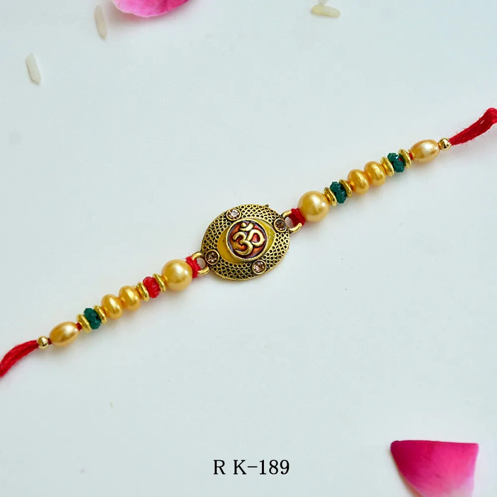 Divine Om Rakhi – RK-189 | Traditional Rakhi with Golden Beads & Sacred Om Emblem