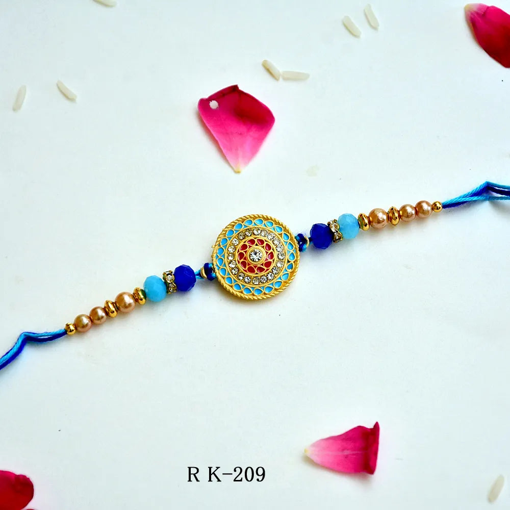 Azure Charm Rakhi – RK-209 | Premium Blue & Gold Circular Rakhi with Crystal Accents