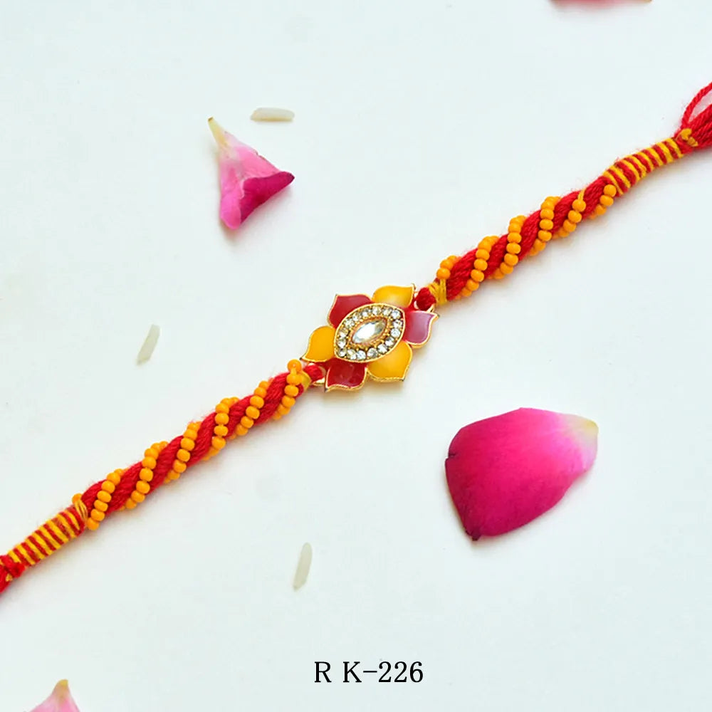 Sunlit Bloom Rakhi – RK-226 | Floral Rakhi with Yellow-Red Thread Work & Crystal Centerpiece