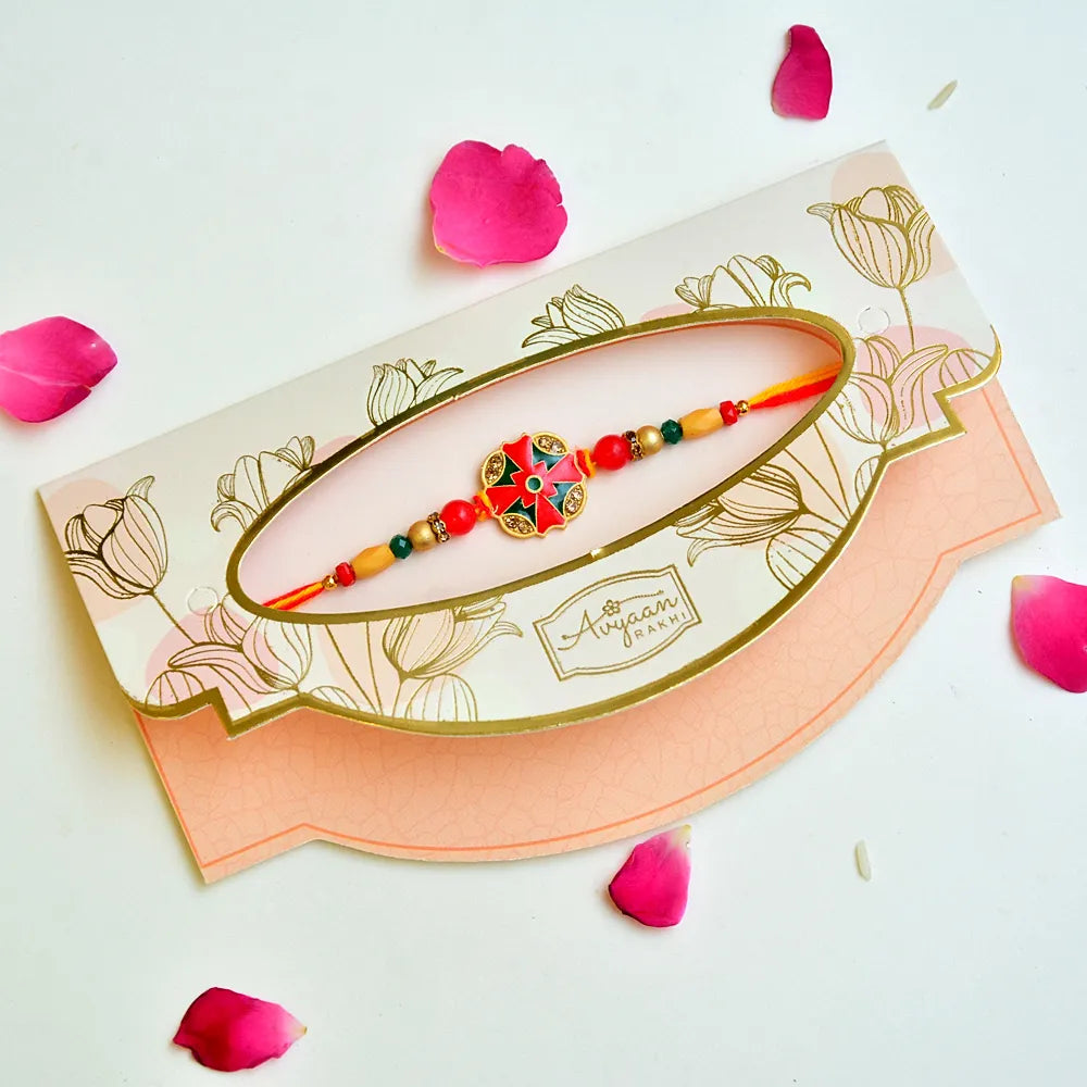 Elegant Floral Motif Rakhi – RK-239 | Red & Green Enamel Centerpiece with Golden Beads & Dual Tone Thread