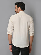 Soft cream-colored men's casual shirt with rolled-up sleeves, stylish and breathable fabric, ideal for everyday wear and versatile fashion looks.