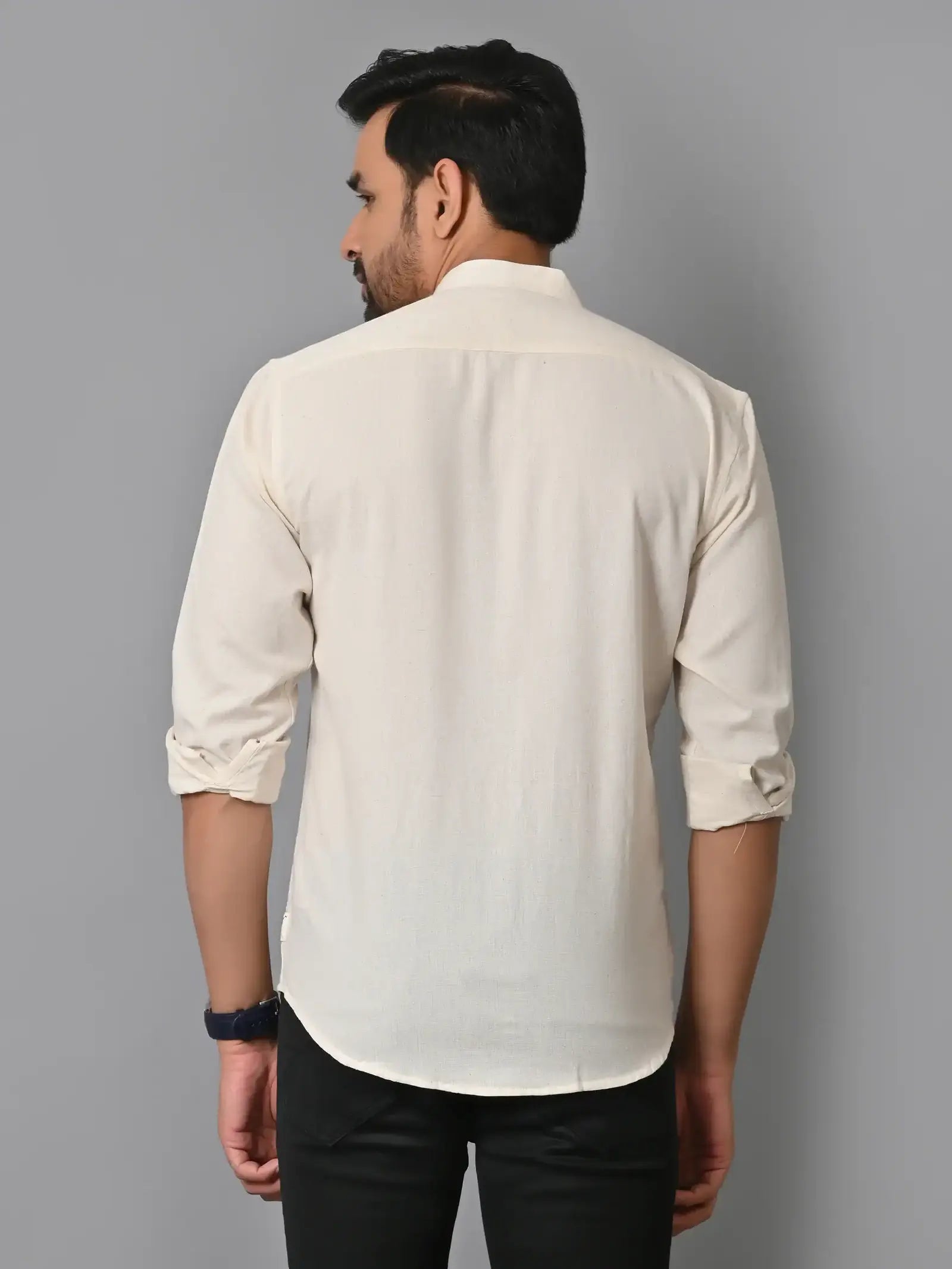 Soft cream-colored men's casual shirt with rolled-up sleeves, stylish and breathable fabric, ideal for everyday wear and versatile fashion looks.