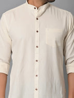 Soft cream-colored men's casual shirt with brown buttons and a chest pocket, made from eco-friendly fabrics, perfect for stylish sustainable fashion.