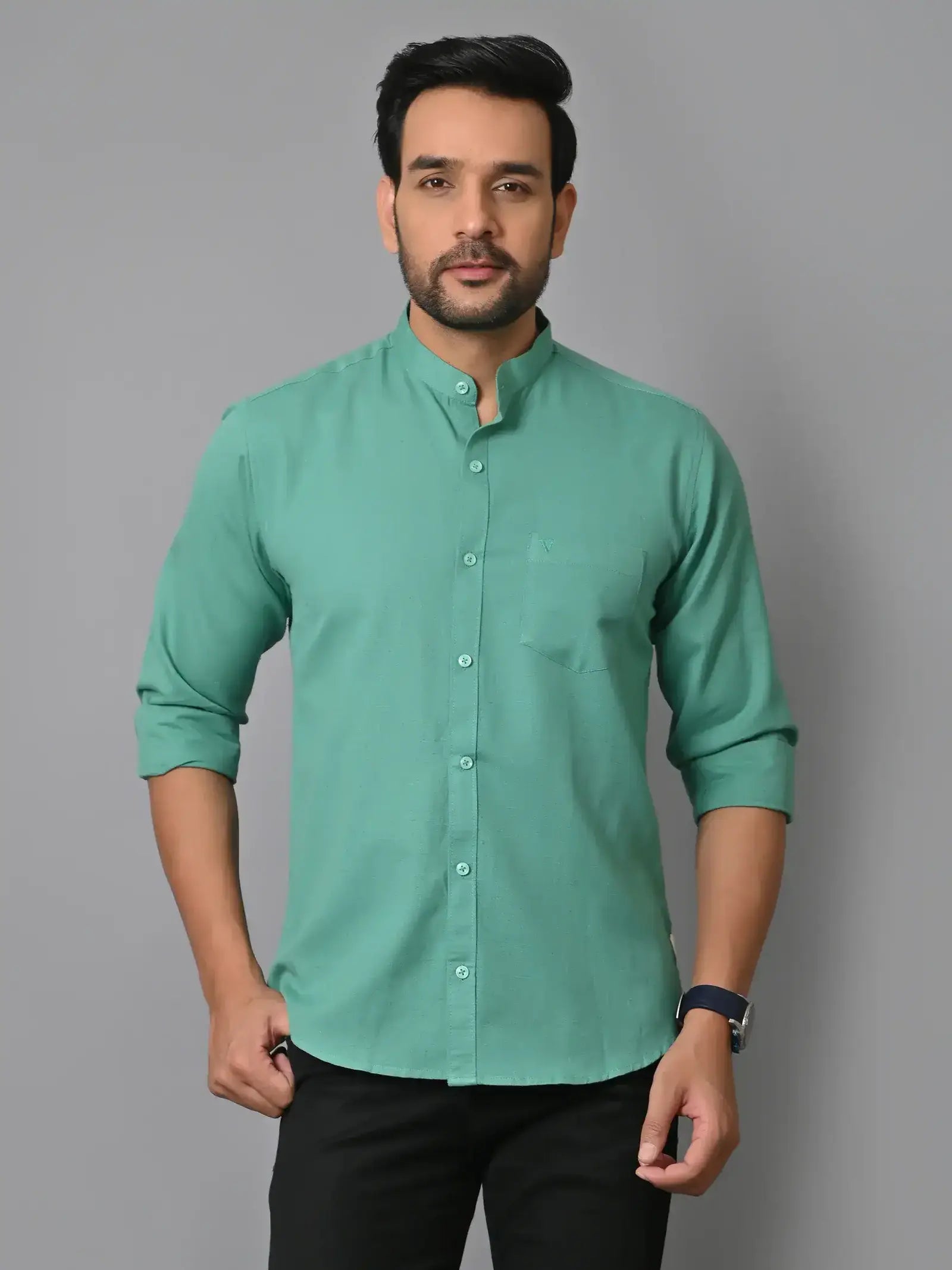 Bright green men's kurta with mandarin collar, long sleeves, and button-down front, perfect for traditional or casual wear, styled with black pants and wristwatch.