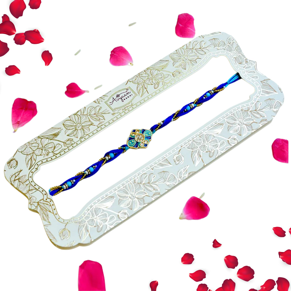 Ocean Bloom Rakhi – RK-228 | Blue Thread Rakhi with Floral Enamel & Crystal Detailing