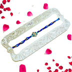 Ocean Bloom Rakhi – RK-228 | Blue Thread Rakhi with Floral Enamel & Crystal Detailing