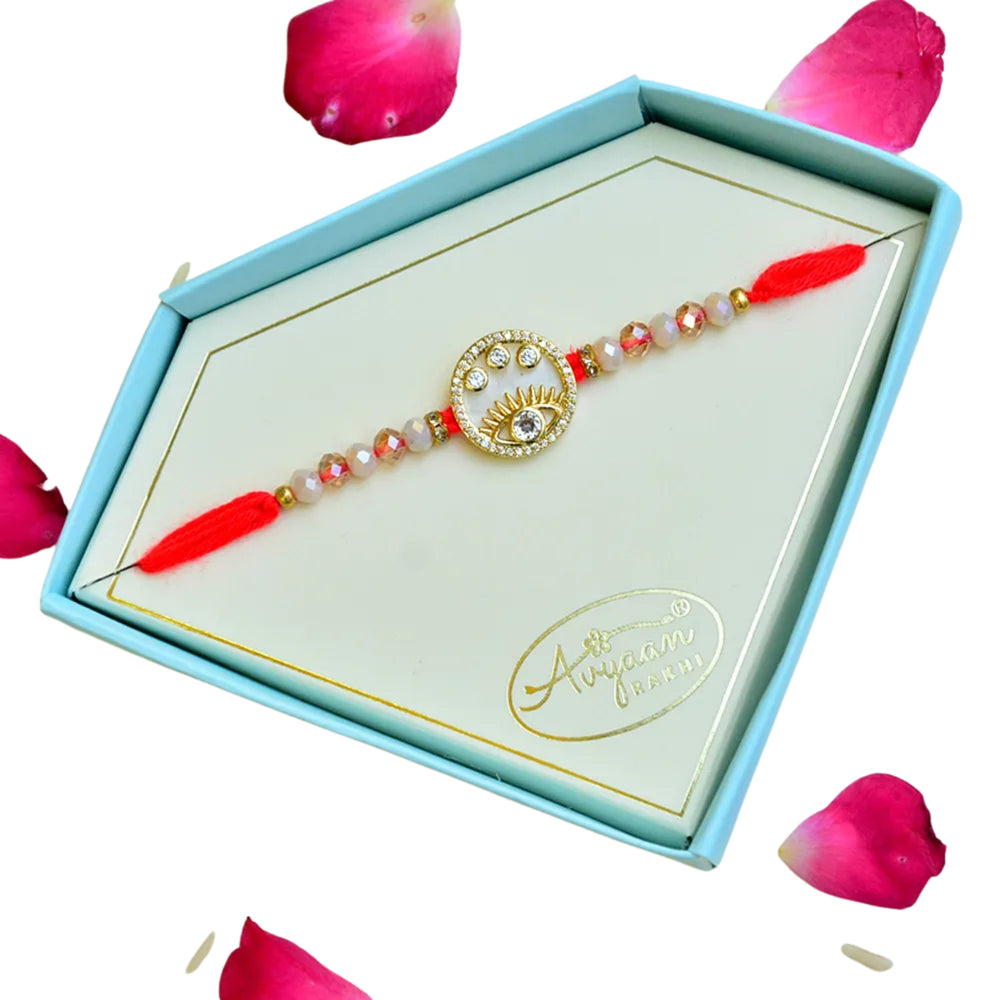 Eye Motif Designer Rakhi – RK-248 | Red Thread with Crystal Beads and Gold Accents