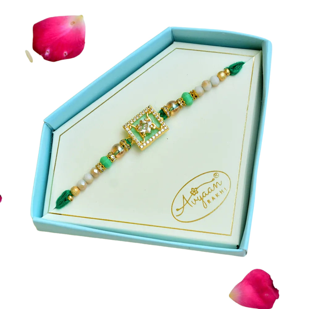 Elegant Green Crystal Elephant Rakhi – RK-247 | Golden Beaded Design with Sparkling Frame