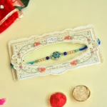 Floral Motif Rakhi – RK-52 | Blue-Green Thread with Pearls & Enamel Charm - Image 2