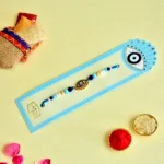 Chic Evil Eye Rakhi – RK-88 | Sleek Gold Charm with Blue & White Beads for Stylish Protection - Image 2