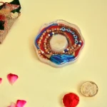 Double-Layered Evil Eye Rakhi – RK-107 | Wooden Bead Rakhi with Evil Eye & Blue Tassels - Image 3