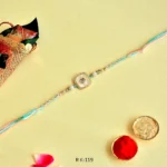 Pastel Elegance Rakhi – RK-119 | Soft Multicolor Thread with Pearl-White Center & Crystal Frame - Image 3