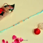 Summer Breeze Rakhi – RK-132 | Aqua Blue Thread with Yellow Beads & Metallic Accents - Image 3