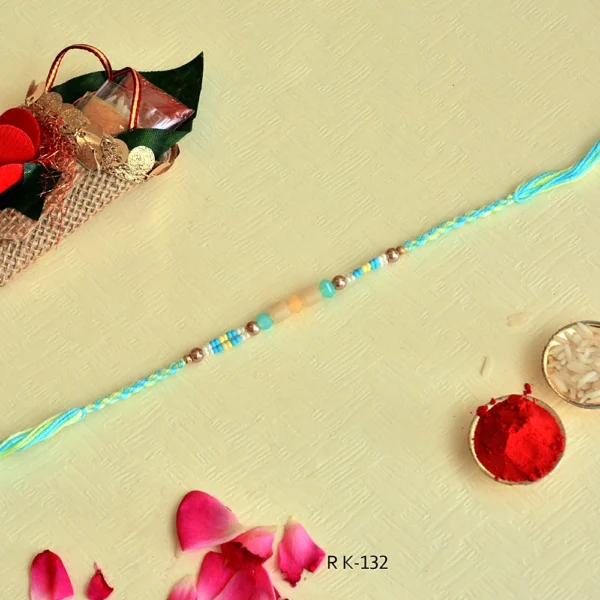 Summer Breeze Rakhi – RK-132 | Aqua Blue Thread with Yellow Beads & Metallic Accents - Image 3