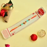 Golden Beaded Rakhi – RK-146 | Red & Green Elegance with Blessings - Image 2