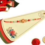 Sunset Blossom Rakhi – RK-44 | Floral Oval Centerpiece with Crystal & Pearl Beads on Dual-Tone Thread - Image 4