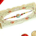 Turquoise Traditional Rakhi – RK-55 | Red-Blue Thread with Golden Beads & Enamel Center - Image 4