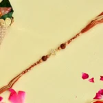 Rudraksha Elegance Rakhi – RK-110 | Divine Design with Subtle Sparkle