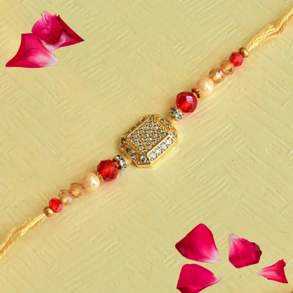 Elegant Golden Crystal Rakhi – RK-116 | Peach Thread with Red & Champagne Beads