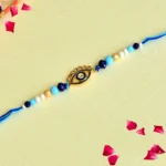 Chic Evil Eye Rakhi – RK-88 | Sleek Gold Charm with Blue & White Beads for Stylish Protection