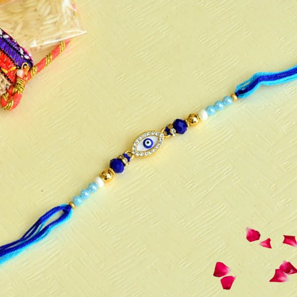 Graceful Evil Eye Rakhi – RK-90 | Dazzling Blue & Gold Beaded Rakhi with Crystal-Studded Nazar Charm