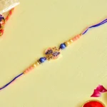 Charming Leaf Motif Rakhi – RK-95 | Elegant Pink & Blue Thread with Pearl and Bead Detailing