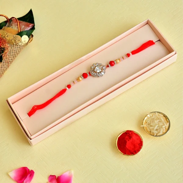 Crystal Bloom Rakhi – RK-118 | Red Thread with Floral Zircon Center & Gold Bead Detailing - Image 2