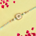 Pastel Elegance Rakhi – RK-119 | Soft Multicolor Thread with Pearl-White Center & Crystal Frame