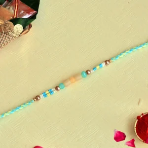 Summer Breeze Rakhi – RK-132 | Aqua Blue Thread with Yellow Beads & Metallic Accents
