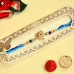 Elegant Ganesh Motif Rakhi - RK-36 | Blue Thread & Beaded Design