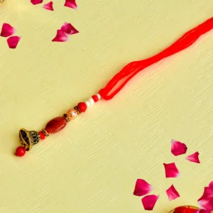 Red Bell Lumba Rakhi – RK-136 | Traditional Design with Beads & Golden Ghungroo for Bhabhi