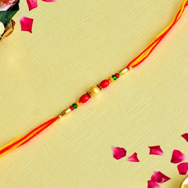 Classic Red & Gold Rakhi – RK-138 | Traditional Beaded Design with Dual-Color Thread - Image 1