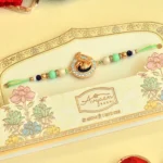 Peacock Theme Rakhi - RK-40 | Elegant Mint Green Thread with Beads & Crystal Accents