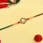 Royal Bloom Rakhi – RK-42 | Floral Kundan Circle with Pearl & Multicolor Thread Finish