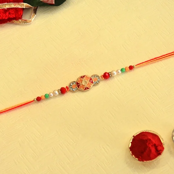 Sunset Blossom Rakhi – RK-44 | Floral Oval Centerpiece with Crystal & Pearl Beads on Dual-Tone Thread - Image 1