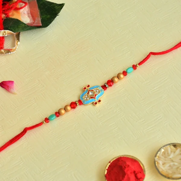 Blue Kundan Designer Rakhi – RK-48 | Intricate Gold Motif with Beads & Crystal Accents - Image 1