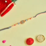 Designer Round Dial Rakhi – RK-51 | Multicolor Thread with Pearls & Crystal Beads