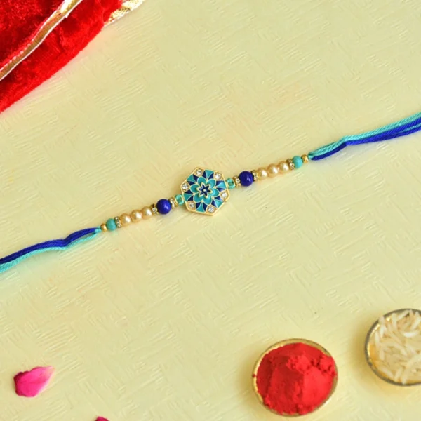 Floral Motif Rakhi – RK-52 | Blue-Green Thread with Pearls & Enamel Charm