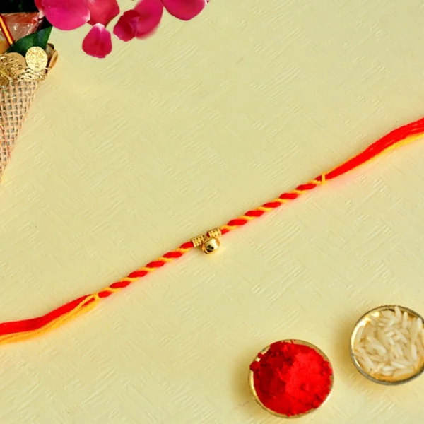 Elegant Red & Yellow Rakhi - RK-149 with Single Gold Bead - Image 1