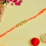 Handcrafted Red-Yellow Rakhi – RK-150 with Beaded Center