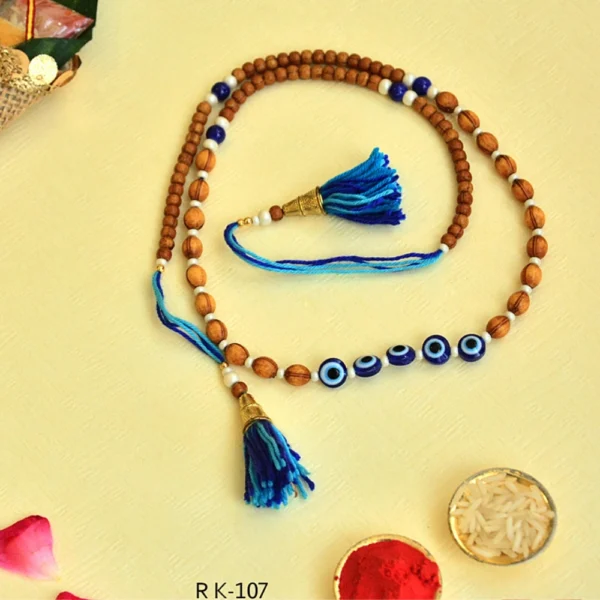 Double-Layered Evil Eye Rakhi – RK-107 | Wooden Bead Rakhi with Evil Eye & Blue Tassels - Image 1