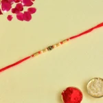 Elegant Rose Bead Rakhi with Red Thread – RK-153