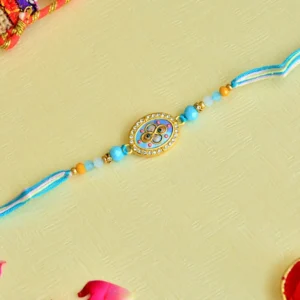 Aqua Bloom Rakhi – RK-61 | Oval Centerpiece with Crystal Detailing & Sky Blue Thread