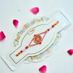 Red Blossom Rakhi – RK-162 | Traditional Rakhi with Floral Centerpiece & Pearl Bead Detailing for Brother - Image 2