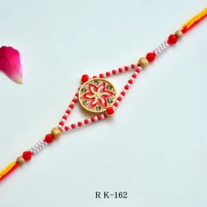 Red Blossom Rakhi – RK-162 | Traditional Rakhi with Floral Centerpiece & Pearl Bead Detailing for Brother