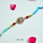Rainbow Charm Rakhi – RK-182 | Colorful Enamel Rakhi with Floral Motif & Multicolor Beads for Brother